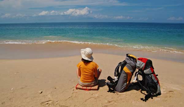 Girl--packs-on-beach